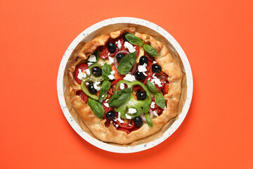 Wall Mural - Freshly baked vegetable galettes in a bowl on an orange background