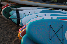Many, A Lot SUP Boards In The Row For Rent On Sandy Beach In Batumi, Georgia. Black Sea. Relax On Vacation At A Tourist Resort.