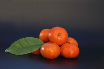 Wall Mural - Group of tangerines on black background