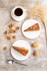 Wall Mural - Walnut and hazelnut cake with caramel on brown concrete. top view, flat lay.