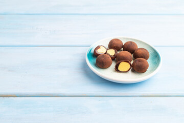 Wall Mural - Japanese rice chocolate mochi filled with cream on blue wooden. side view, copy space.