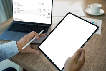 Poster - A businessman holds a mockup. iPad digital tablet with blank screen Mockup replaces your design mockup in the office.