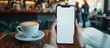 Woman hand holding a mobile phone white blank screen for mockup at coffee shop. Generated AI image