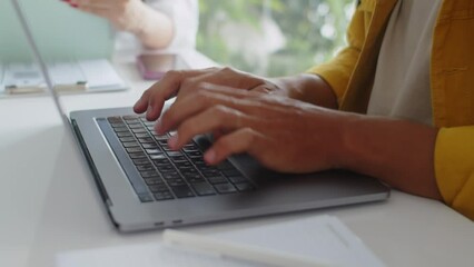 Cropped shot of unrecognizable male programmer working on app code using wireless laptop