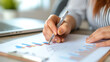 © สรศักดิ์ ธรรมวงษ์ษา - Close up female accountant's hands at desk using chart for financial reporting in office business finance concept. Generative AI illustration