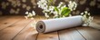 rolled yoga mat and blooming branches with white flowers, resting on a wooden floor, creating a serene and inviting atmosphere.