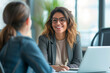 © Moritz - Happy businesswoman interviewing a well-prepared job candidate in a cozy office environment. The job interview process - from expectation to excitement, captured in high-definition