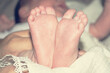 Children's little legs. A newborn baby. Baby's little fingers. Part of the baby's body