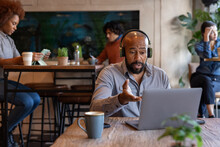 African American freelancer working from a cafe on a video call 