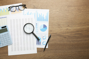 Poster - Accounting documents, magnifying glass, stationery and glasses on wooden table, top view. Space for text