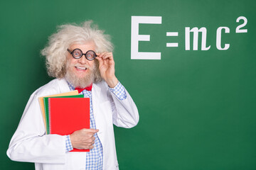 Wall Mural - Photo of crazy excited old man hold notebooks college professor wear glasses mathematics isolated on green color background