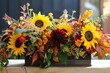 A Thanksgiving themed floral arrangement with sunflowers, dahlias, and autumn foliage