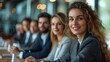 © AdriFerrer - Smiling curly-haired businesswoman at a corporate meeting.