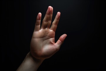 Poster - A person is shown holding their hand up in the air. This image can be used to represent victory, celebration, or raising awareness