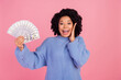 © deagreez - Photo of impressed funky woman wear blue pullover rising dollars fan arm cheek isolated pink color background