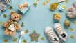 baby concept top view vertical photo of gift boxes shoes socks pacifier teddy bear teether bottle knitted bunny rattle toy gold stars on pastel blue background with copyspace in the middle