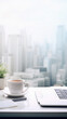 White office desk with laptop, coffee cup and notebook on blurry city background