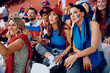 © Drazen - Group of young sports fans watching game from stadium stands.