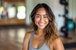 thai smiling happy female yoga instructor in a fitness studio