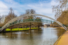 A View Past The Suspension Bridge Over The River Great Ouse Towards Bedford, UK On A Bright Sunny Day