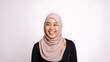 © fahryashari - Radiant smile of a beautiful Asian woman with a hijab, capturing genuine joy and warmth, against a gray background