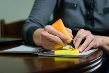 Woman Using Marker And Sticky Notes While Working From Home.