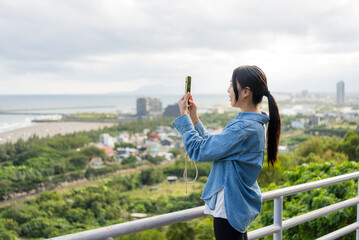 Sticker - Tourist woman use mobile phone to take photo in Yilan of Taiwan