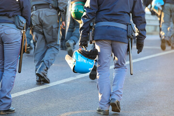 Wall Mural - policemen in uniform with riot gear during the protest demonstration with helmets and shields