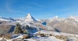 Fototapeta Lawenda - Majestic mountain peaks full of stacked rock hiker cairns with famous Matterhorn view background during winter in Switzerland. Swiss alps wonderful inspiring nature landscape.