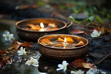 Serene Floating Candles In Bronze Bowls Amidst Autumn Leaves And White Flowers