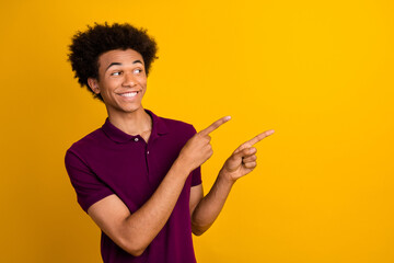 Wall Mural - Photo of satisfied man wear stylish violet polo two arms direct empty space seasonal offer news isolated on yellow color background