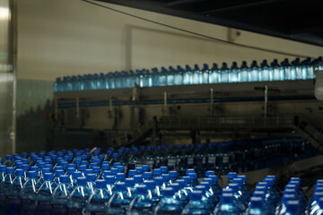 Aufkleber - Abundance of capped plastic bottles with purified mineral water moving on conveyor belt at large modern factory of bottled drinks