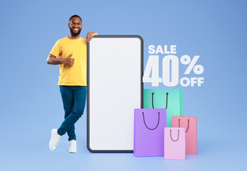 Poster - African Buyer Guy Near Smartphone Gesturing Thumbs Up, Blue Backdrop