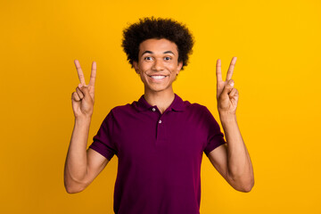 Canvas Print - Photo of glad positive guy wear trendy purple clothes showing v-sign good mood isolated on yellow color background