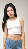 Fototapeta Sport - photo of beautiful young asian woman with crop white top and jeans standing at white backdrop, generative AI