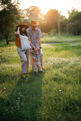 happy harmonious family outdoors concept father and mother and son have activities together on holidays, nature grassland field