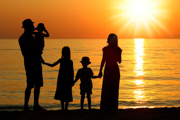 Canvas Print - A happy family by the sea in nature silhouette weekend travel