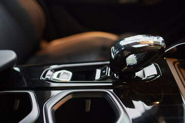 Wall Mural - Selector automatic transmission with leather in the interior of a modern expensive car. The background is blurred. Black and brown leather car.