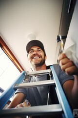 Poster - A man is standing on top of a blue ladder. This image can be used to depict concepts such as success, achievement, reaching goals, or taking risks