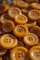 Poster - A pile of yellow buttons sitting on top of a table. This image can be used for various crafting and sewing projects