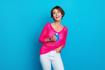 Wall Mural - Photo of dreamy good mood woman wear knitted neon shirt drinking lemonade looking empty space isolated blue color background