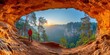 Sunrise Explorer: A Lone Hiker Witnesses the Splendor of Nature from a Cave's Vantage Point Overlooking a Forested Valley, Generative AI