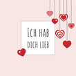 Ich hab dich lieb - Schriftzug in deutscher Sprache. Quadratische Liebesbotschaft mit hängenden Herzen und rosafarbenem Rahmen.