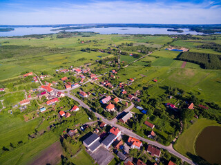 Wall Mural - Aerial view of beautiful Radzieje village (former Rosengarten, East Prussia), Mamry, Labap and Dargin lakes in the background, Mazury, Poland