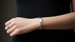 Close up of minimalist metal permanent jewelry wristband in a woman's wrist.