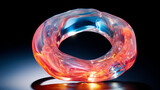 Fototapeta Perspektywa 3d - Macro image of a reflective translucent ring with swirling red and blue tones and an incandescent quality.