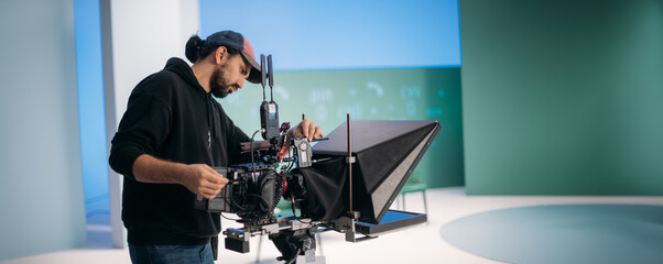 Wall Mural - Director of photography with a camera in his hands on the set. Professional videographer at work on filming a movie