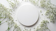 White round frame with small delicate white flowers on white background. wedding cards, bridal shower or other party invitation cards, Place for text. Flat lay, top view.