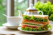 English tea paired with a homemade sandwich made of luncheon meat and lettuce set against a background
