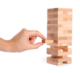 Poster - Playing Jenga. Man removing wooden block from tower on white background, closeup